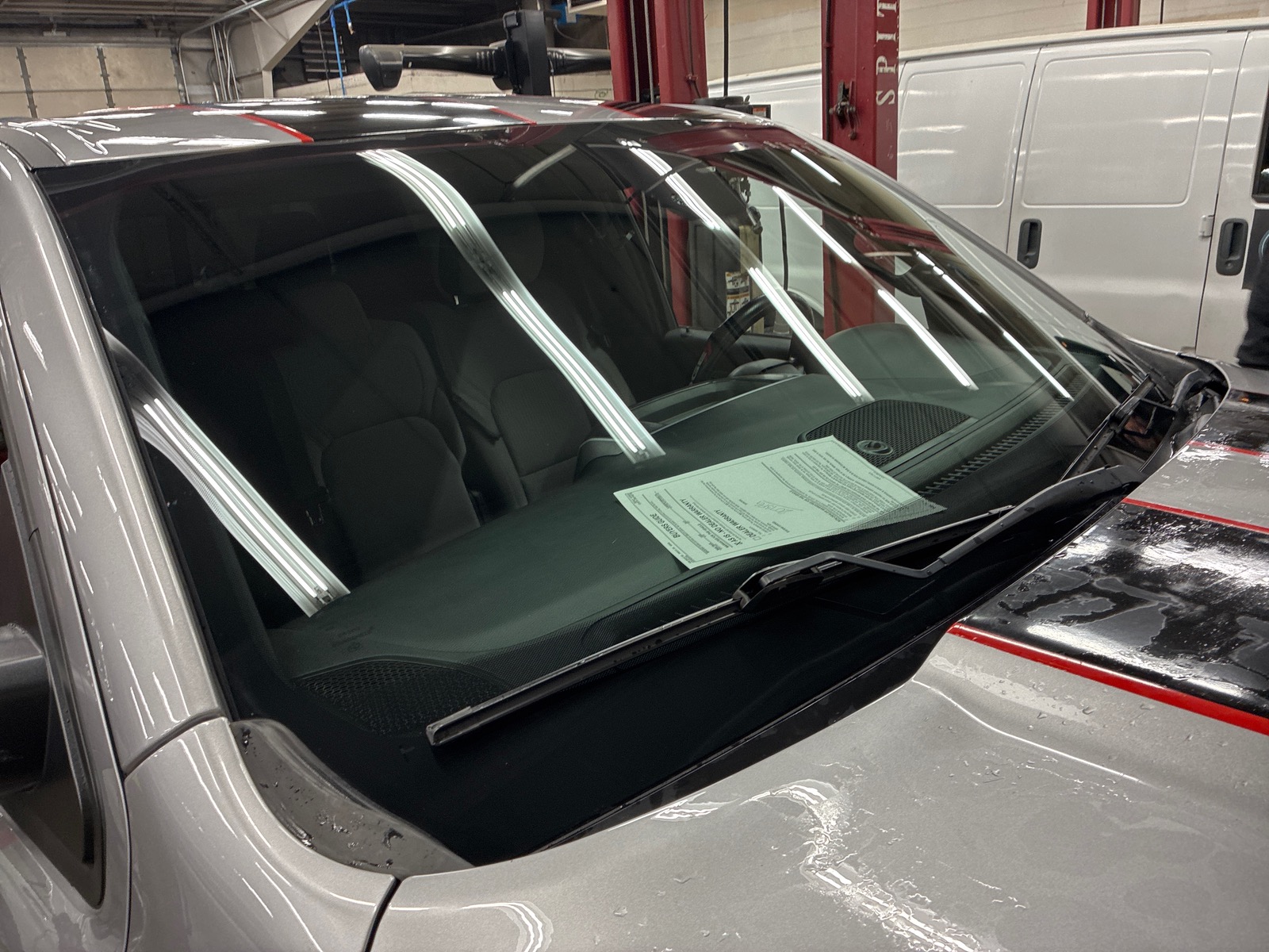 Newly installed windshield in an auto glass shop