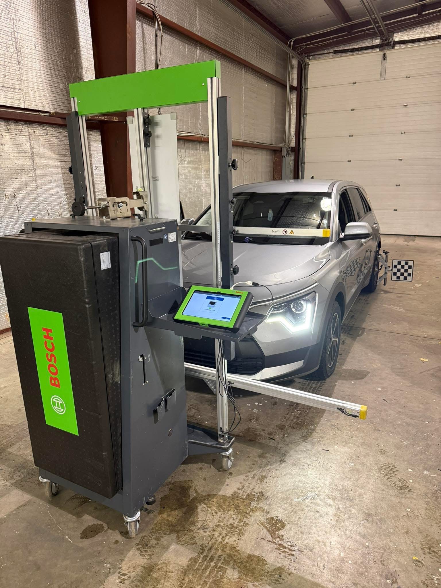 ADAS calibration equipment positioned in front of a vehicle
